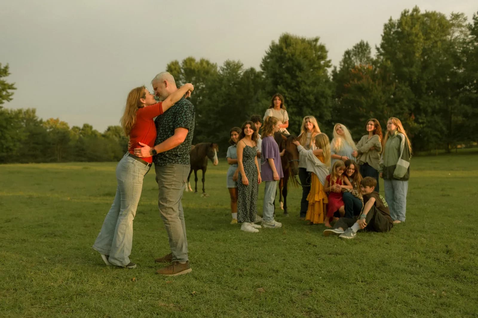 Sarah and Josh dancing with kids watching