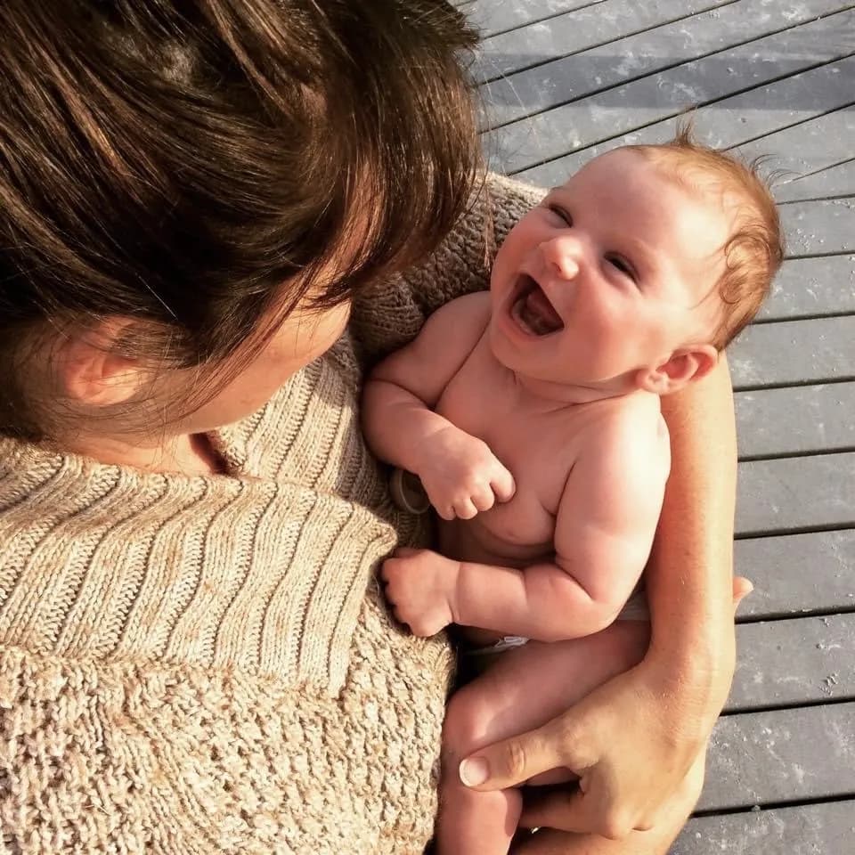 Sarah with laughing baby